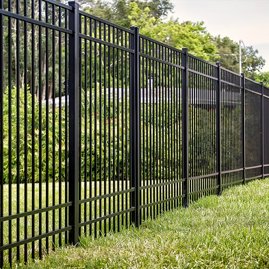 Black metal fence on green lawn