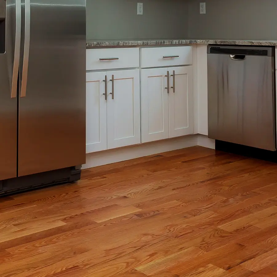 Modern kitchen with stainless steel appliances and hardwood floor