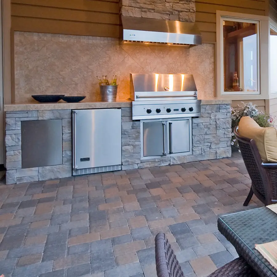 Modern outdoor kitchen with stone grilling area.