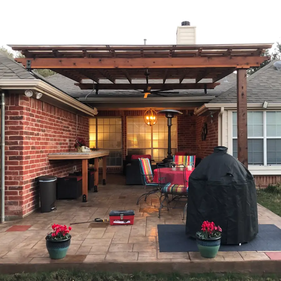 Cozy backyard patio with pergola and colorful seating.